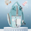 A light blue backpack with a bear print design and a white pocket is shown against a soft blue background.