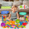 A young girl is playing with colorful counting animal sorting toys and various colored plastic items on a table.