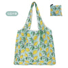 A light green reusable shopping tote bag patterned with yellow citrus leaves and green foliage.