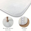 Close-up view of a white microfiber quick-dry mat showing its thickness and surface texture.