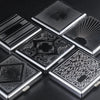 A collection of classic stainless steel cigarette cases with various embossed patterns and designs.