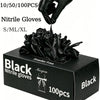 A box of black powder-free nitrile gloves is shown with a hand putting on a glove.