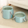 Light blue collapsible foot bath tub with a mesh liner and gray straps resting on a beige carpet.