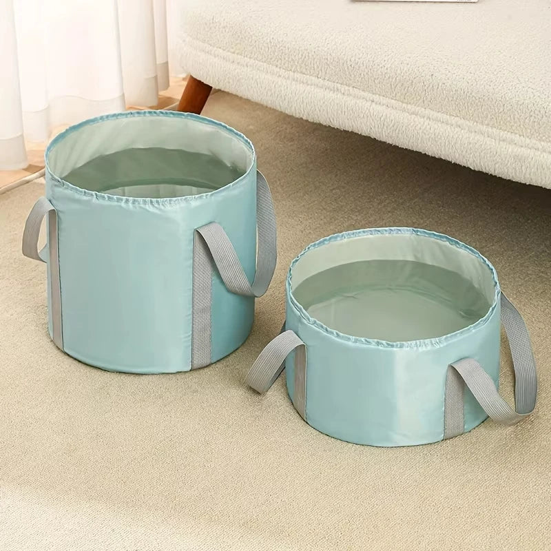 Light blue collapsible foot bath tub with a mesh liner and gray straps resting on a beige carpet.