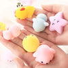 A hand holds several soft, squishy animal-shaped stress relief toys in yellow, pink, and blue colors.