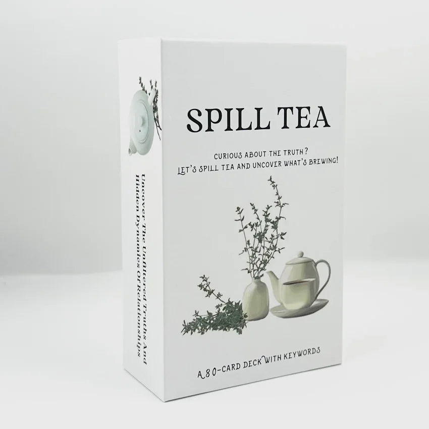 A box of Spill Tea Oracle Card Deck with keywords featuring a teapot and greenery.