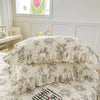 A set of two floral cotton pillowcases with ruffled edges on a bed.