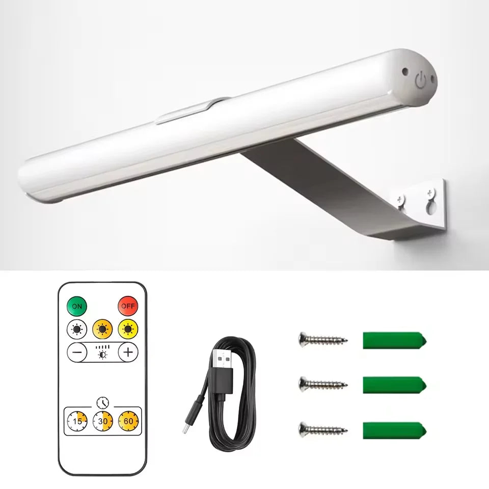A white cordless rechargeable picture light fixture mounted on a wall, shown alongside its power cord and mounting hardware.