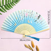 A light blue folding hand fan decorated with floral and butterfly patterns, shown against a pink background.