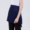 A navy blue classic half apron with pockets shown on a person's torso.