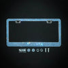 A rectangular crystal rhinestone license plate frame with mounting tabs and various small components.