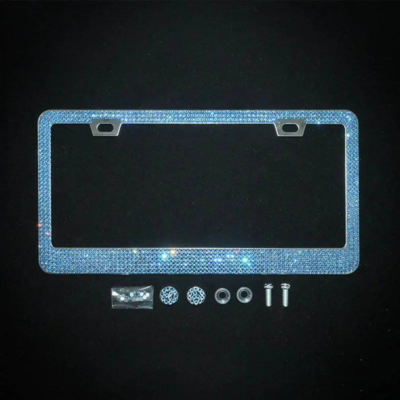 A rectangular crystal rhinestone license plate frame with mounting tabs and various small components.