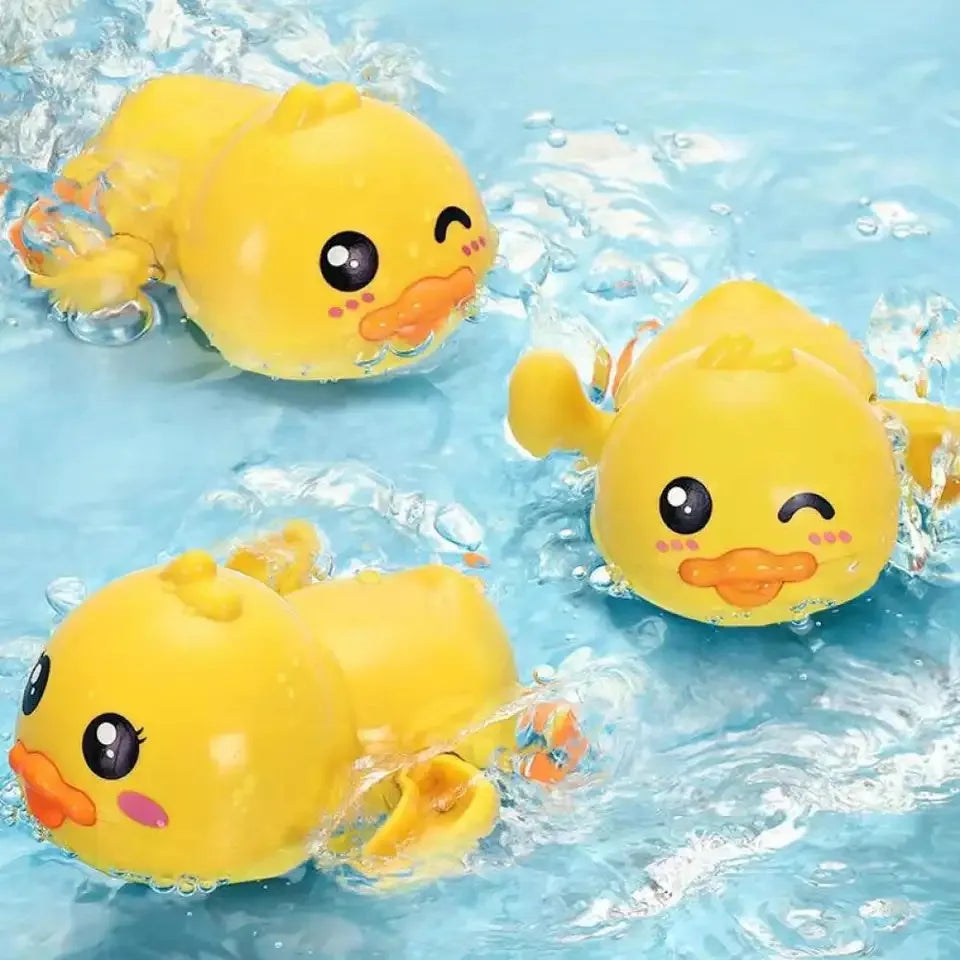 A yellow wind-up bath toy duck floating in clear water.