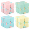 A set of colorful Infinity Magic Cube fidget toys in pink, mint green, and light yellow.