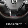 Close-up view of a black steering wheel cover with a leather grip and airbag housing in a car interior.