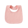 A pink soft cotton baby bib with a rounded shape and a small white button closure.