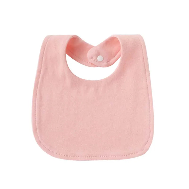 A pink soft cotton baby bib with a rounded shape and a small white button closure.