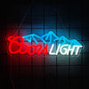 Red and blue neon sign spelling out COOLS LIGHT against a dark grid background.