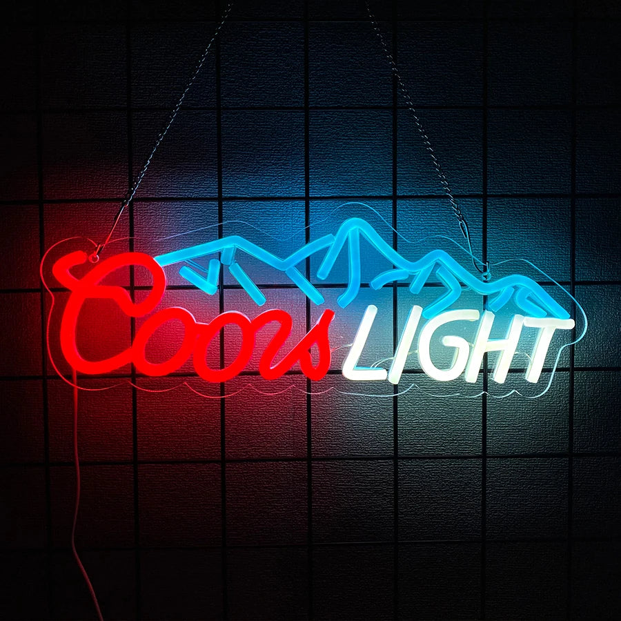 Red and blue neon sign spelling out COOLS LIGHT against a dark grid background.