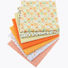 A stack of colorful cotton fabric squares featuring various floral and geometric dot patterns for patchwork and quilting.