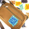 A tan canvas pouch with a zipper is shown alongside various yellow and green motivational iron-on patches.
