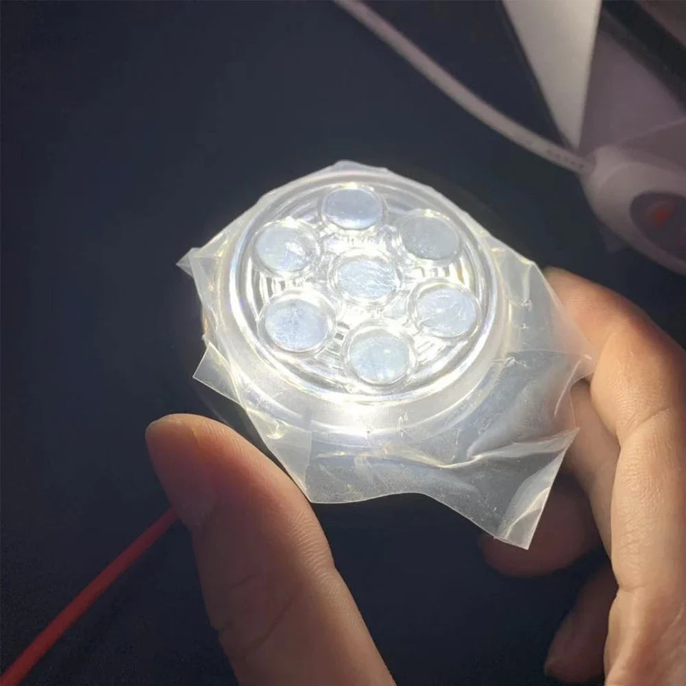 A hand holds a clear plastic light assembly with seven LEDs, intended for truck or RV tail lights.