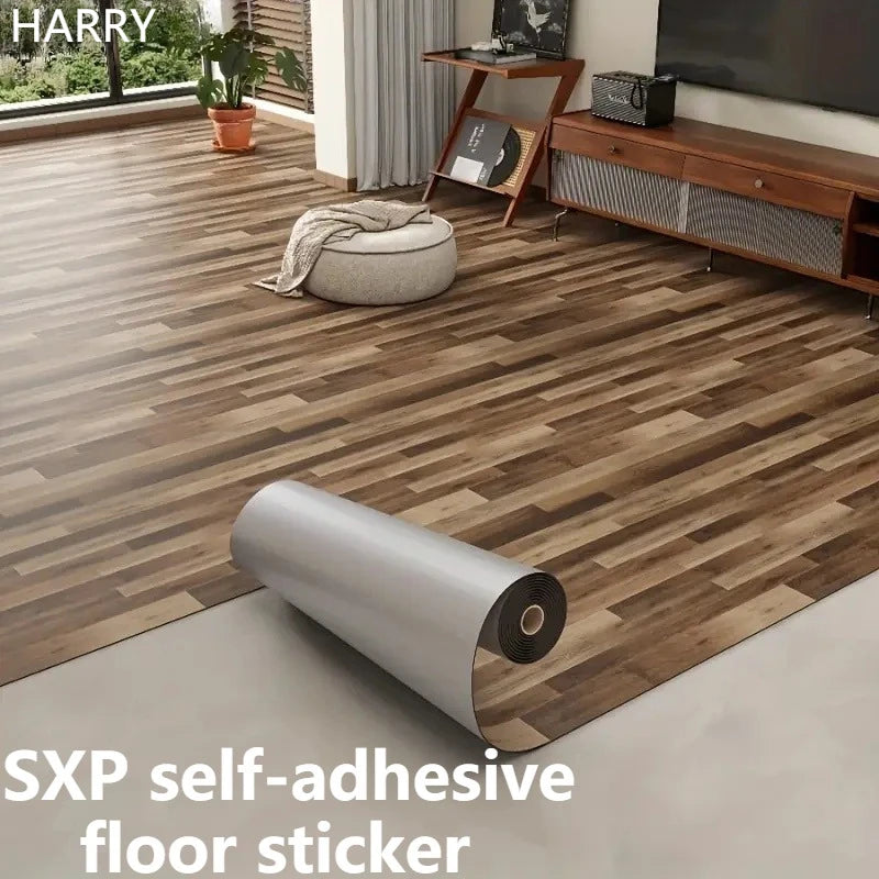 A roll of gray self-adhesive floor sticker is shown on a wooden floor next to furniture.