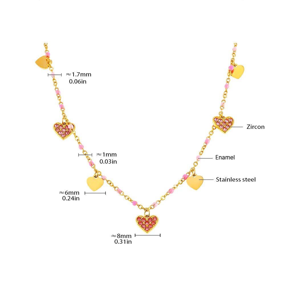 Gold heart charm necklace featuring zircon and enamel accents on a stainless steel chain