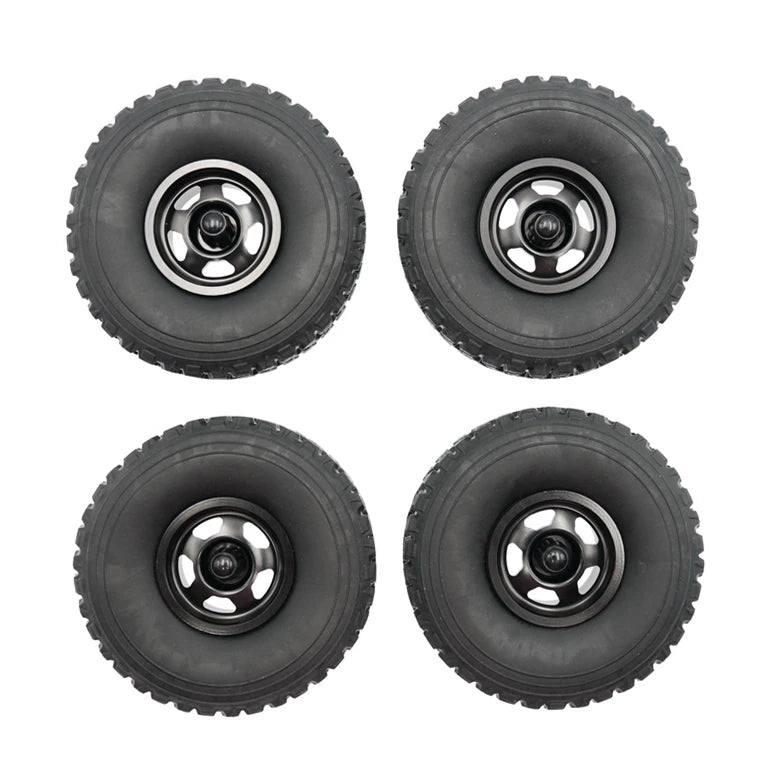 Four black RC car upgrade wheels with metal rims and soft tires shown from the top.