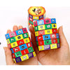 A hand holds a colorful Montessori math cube toy featuring numbers and arithmetic symbols.