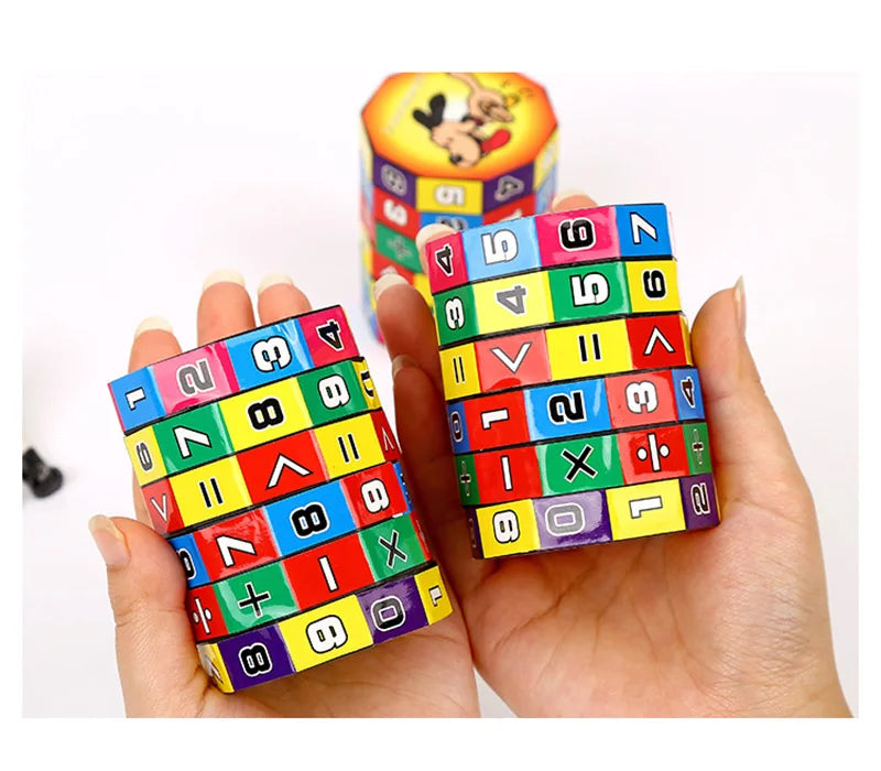 A hand holds a colorful Montessori math cube toy featuring numbers and arithmetic symbols.