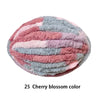 A ball of pink and blue chenille yarn showing a marbled pattern for hand knitting projects.