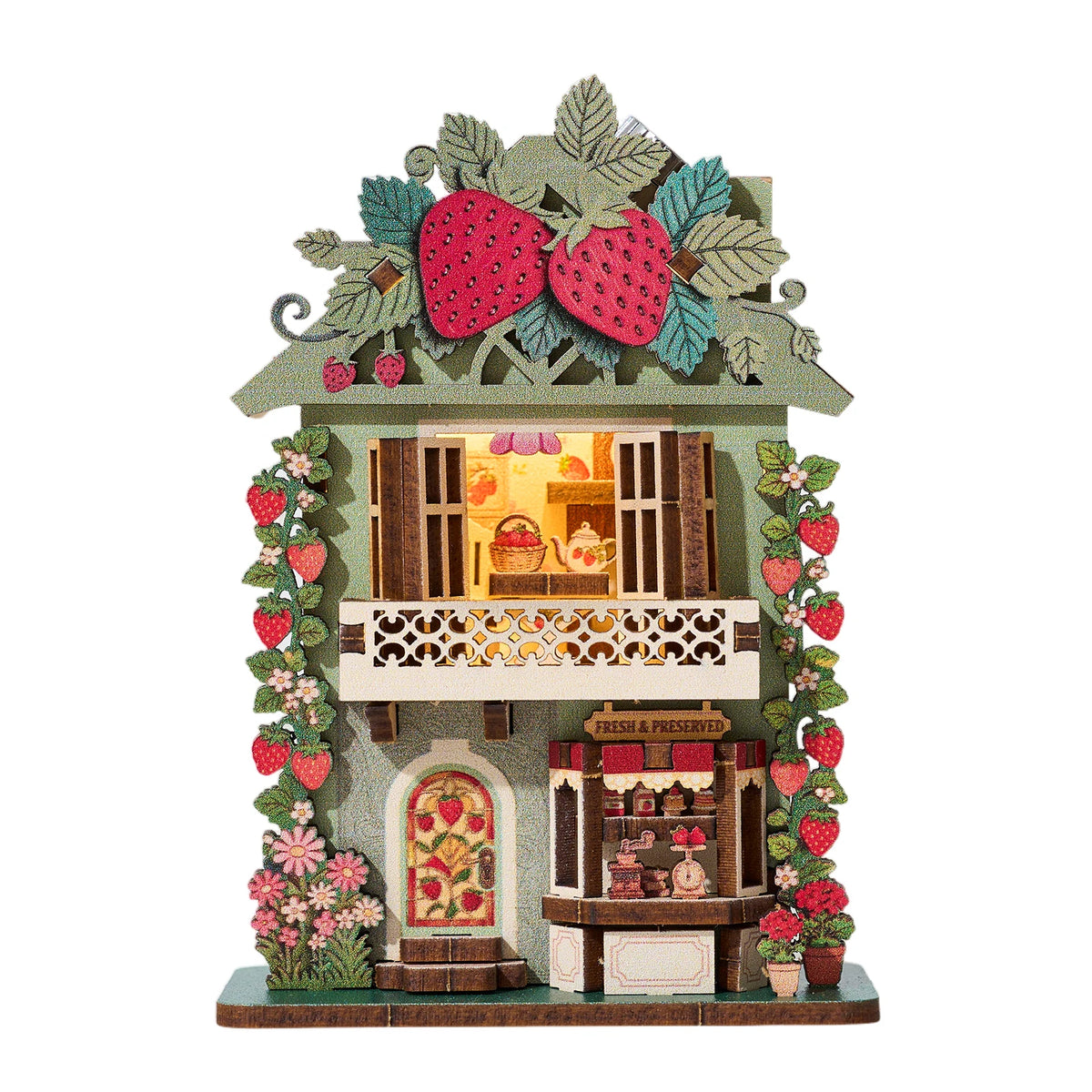 A decorative DIY book nook featuring a strawberry-themed facade with LED lighting and preserved fruits.