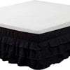 Black elastic bed skirt with a white top covering the mattress to hide under-bed space