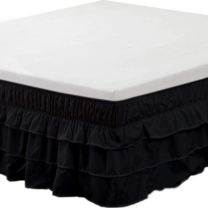 Black elastic bed skirt with a white top covering the mattress to hide under-bed space