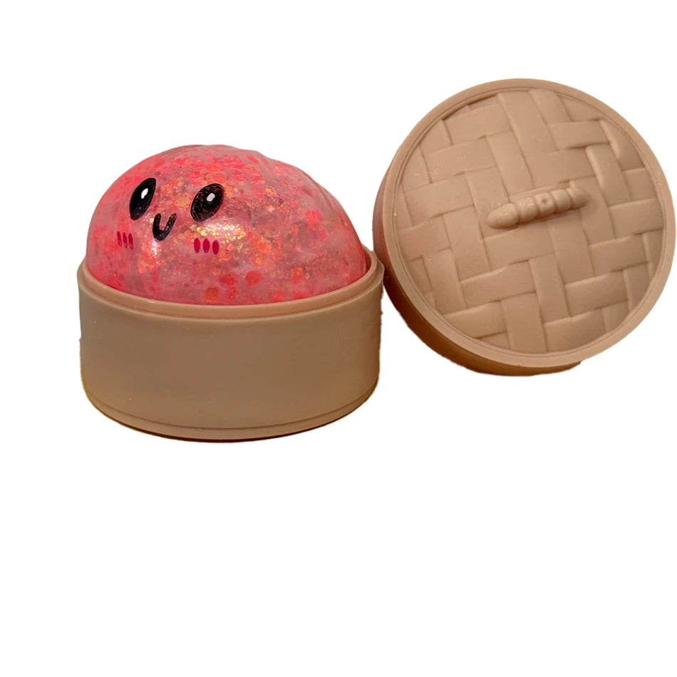Pinkes glitzerndes Squishy-Dumpling-Sensorikspielzeug mit passender beige Deckel.