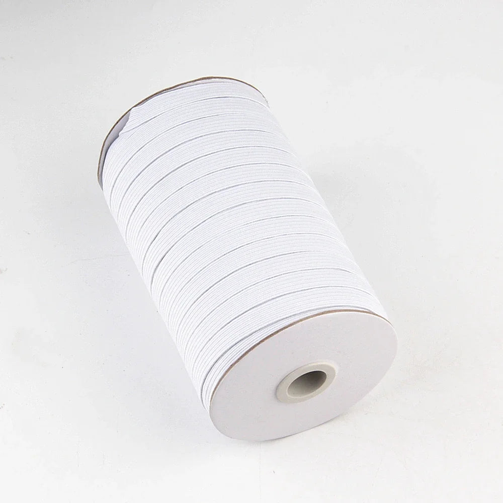 A roll of white polyester elastic bands for sewing and crafts.