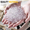 Hands hold a pile of clear pink acrylic crushed ice gems for vase fillers and decor