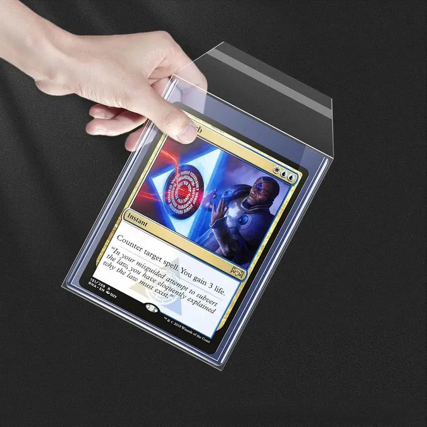 A hand holds a clear magnetic card protector sleeve displaying a Magic: The Gathering card featuring a dark-skinned character