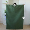 A dark olive green heavy-duty canvas laundry bag is displayed, showing its dimensions and texture.