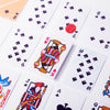 A close-up view of a deck of classic poker playing cards showing various face cards and numbered cards.