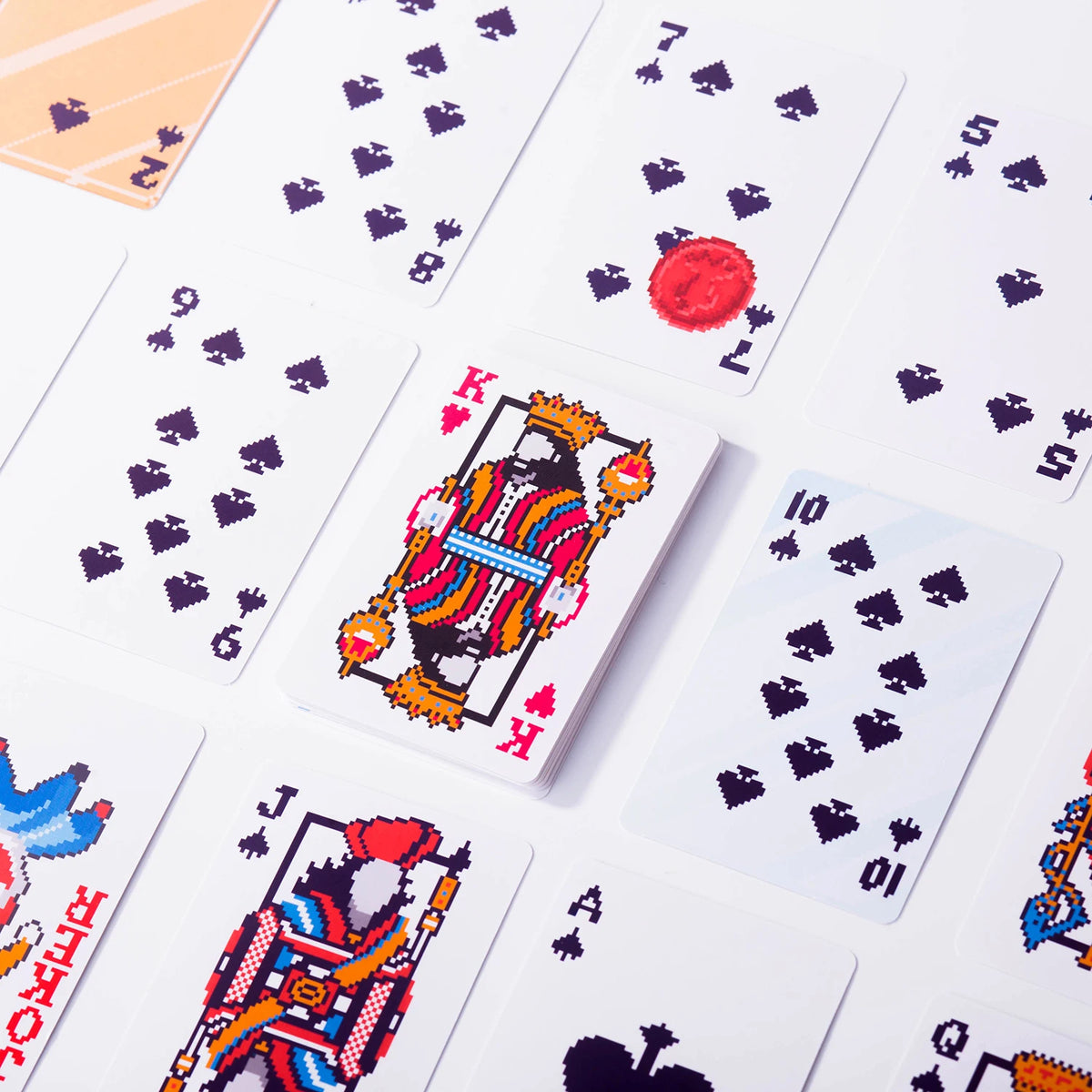 A close-up view of a deck of classic poker playing cards showing various face cards and numbered cards.
