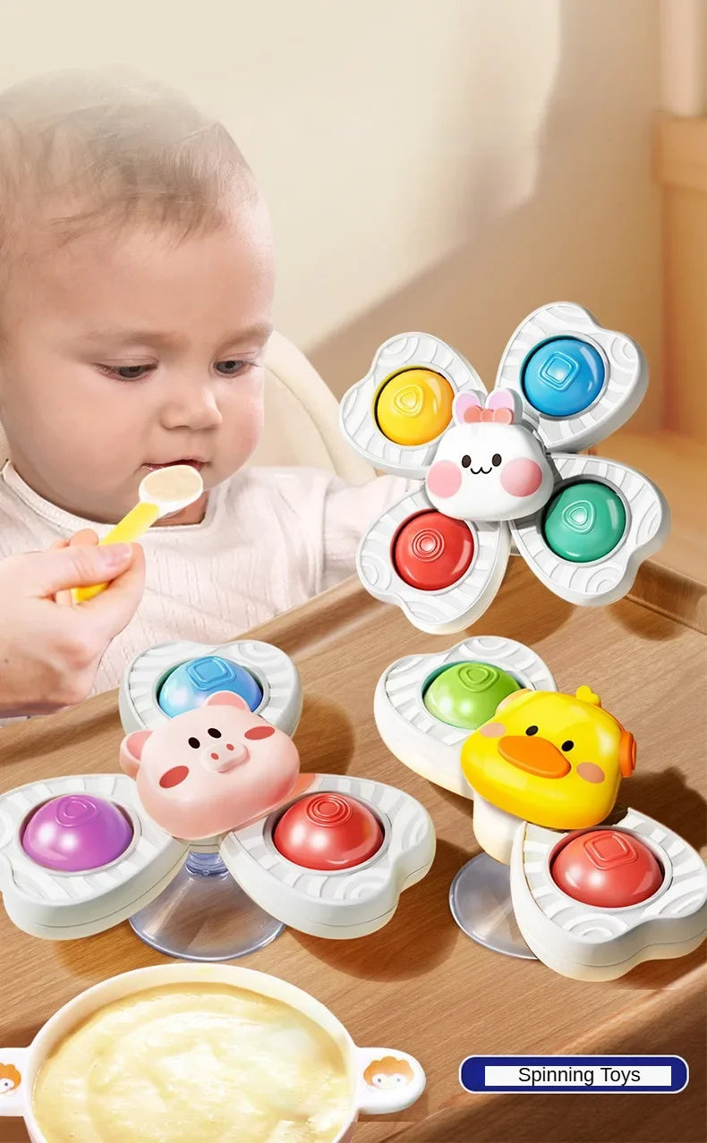 A set of spinning bath toys for toddlers featuring various colored, foam-like wheels and a yellow duck.