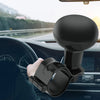 A hand is operating a black universal steering wheel spinner knob on a car's steering wheel.