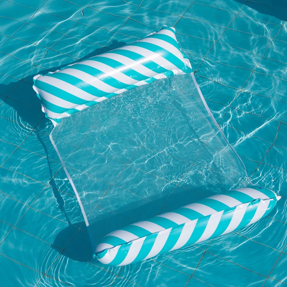 A striped inflatable lounge chair with a mesh net backrest floating in clear blue water.