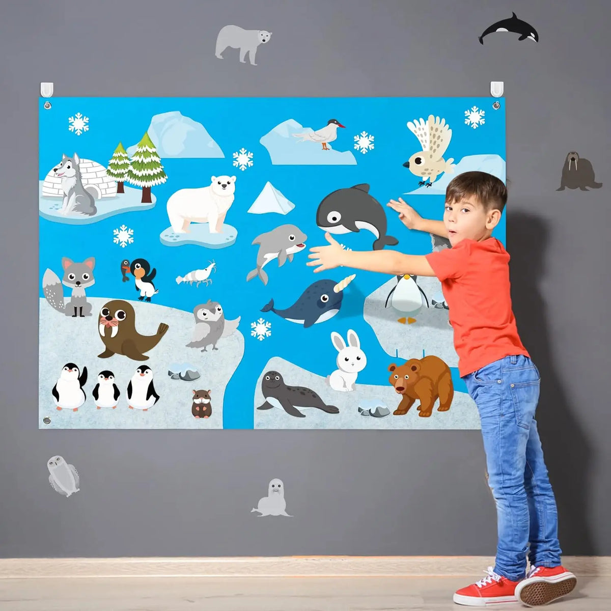 A child stands in front of a blue felt board featuring various farm and wild animals like bears, deer, birds, and mammals.