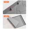 A close-up view of a silicone mat designed to protect under sink cabinets, showing its texture and shape.