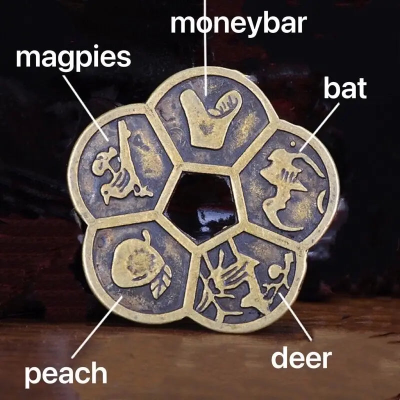 A set of traditional Chinese Feng Shui brass lucky coins featuring animals like magpies, bat, peach, and deer.