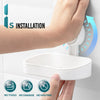A hand installs a white suction cup soap dish holder with a removable tray onto a white wall.