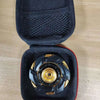 Black precision metal fidget spinner with gold accents resting in a padded black case.